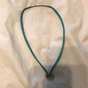 Leather necklace with silver necklace.